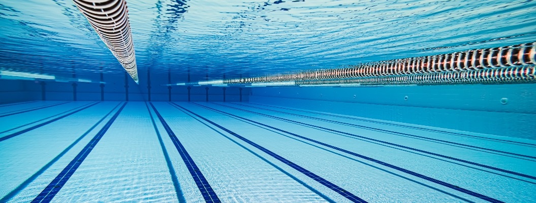 Olympic Swimming pool under water background.