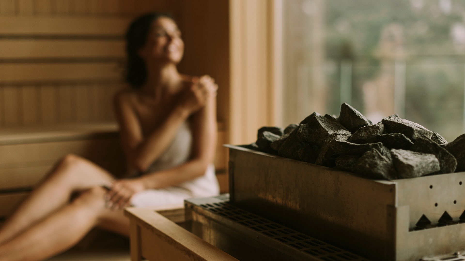 Young woman relaxing in the sauna